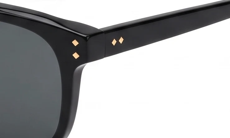 Close-up of Les, gold diamond rivets on gloss black acetate