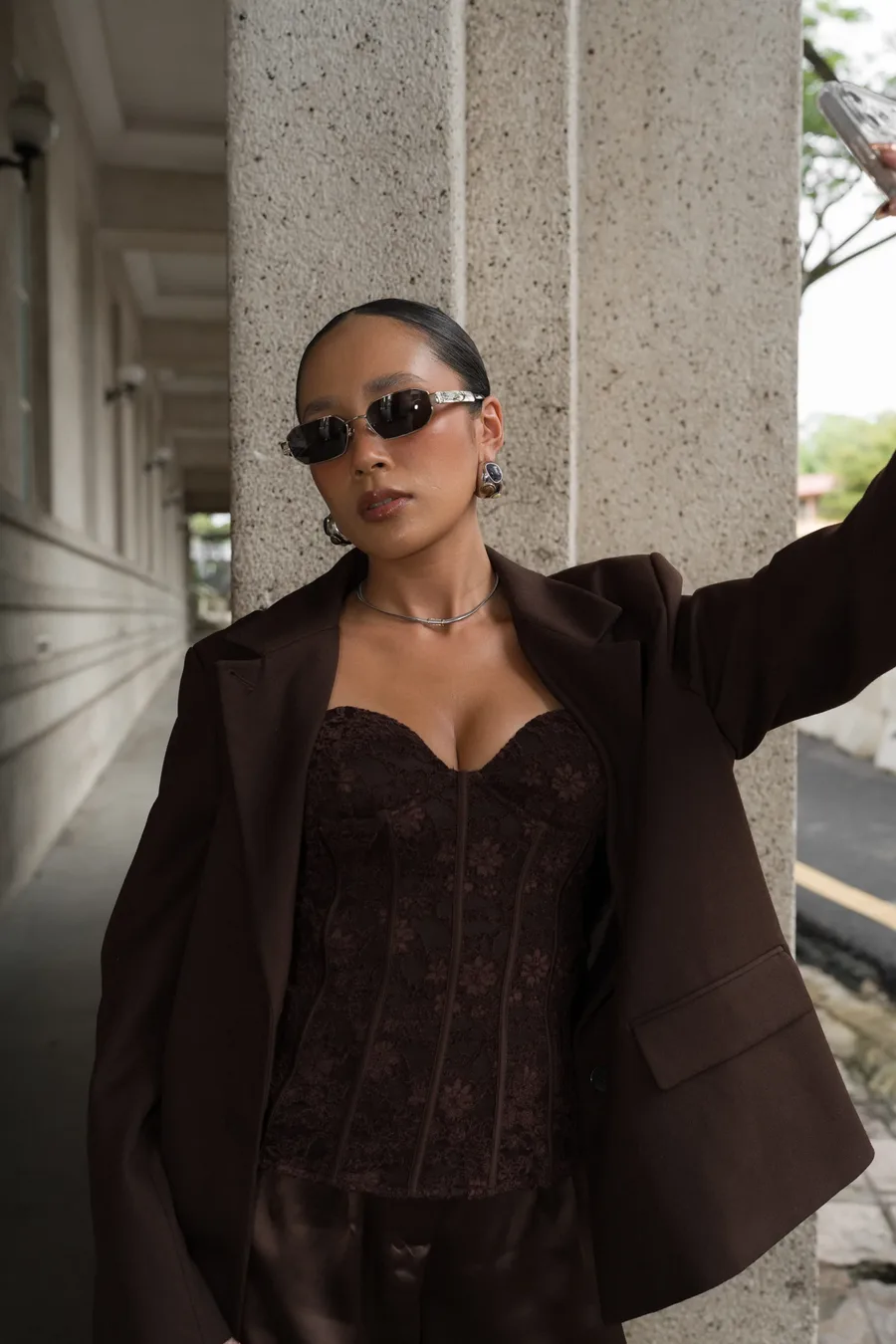 Full look in a brown blazer and lace corset wearing Maison