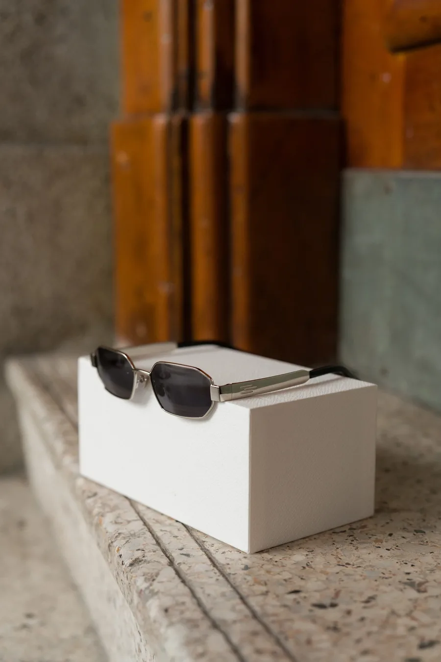 Maison sunglasses displayed on a white block